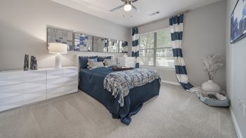 Model bedroom with ceiling fan and furniture